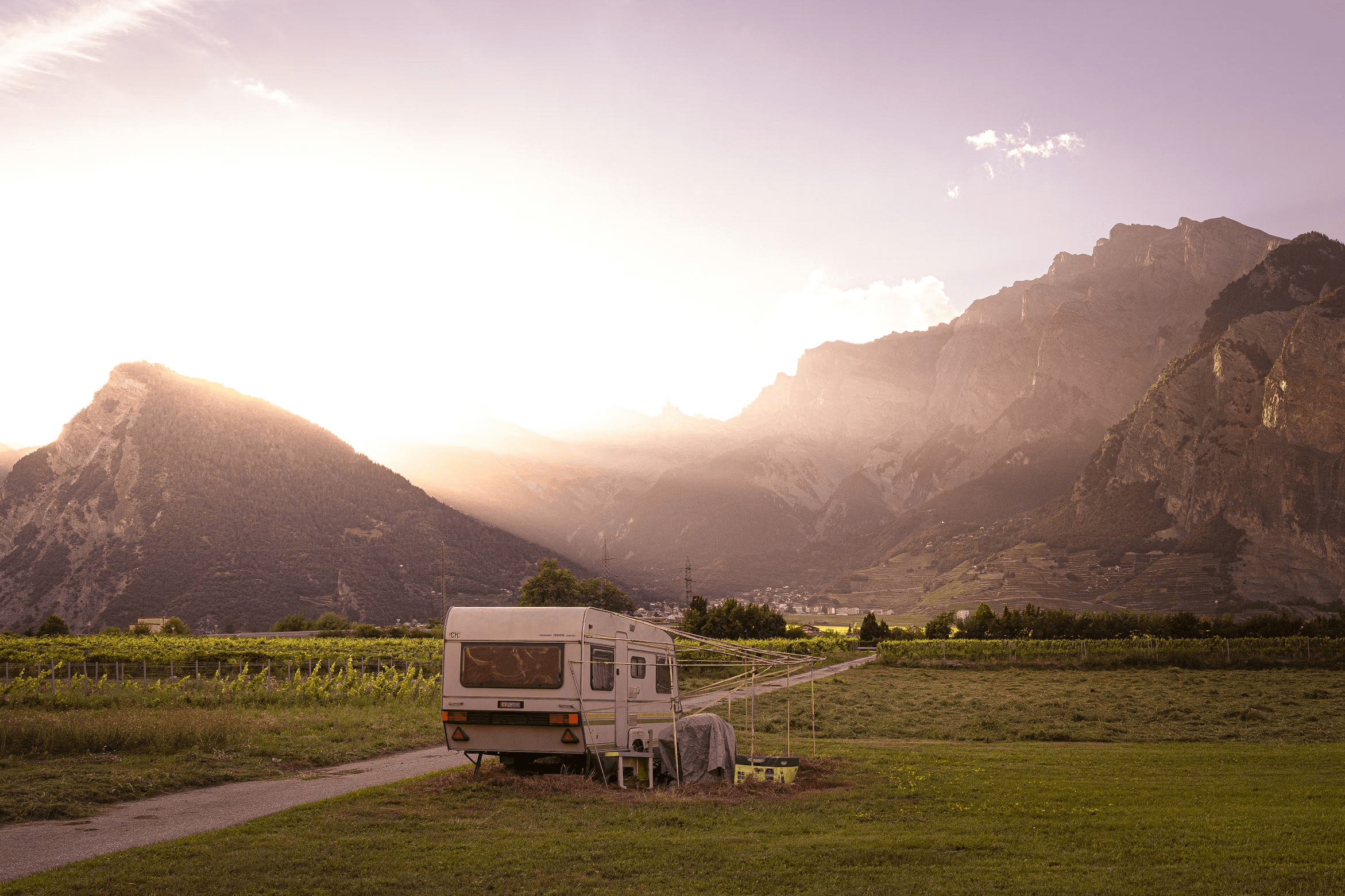 Camper house parked in a mountain valley landscape