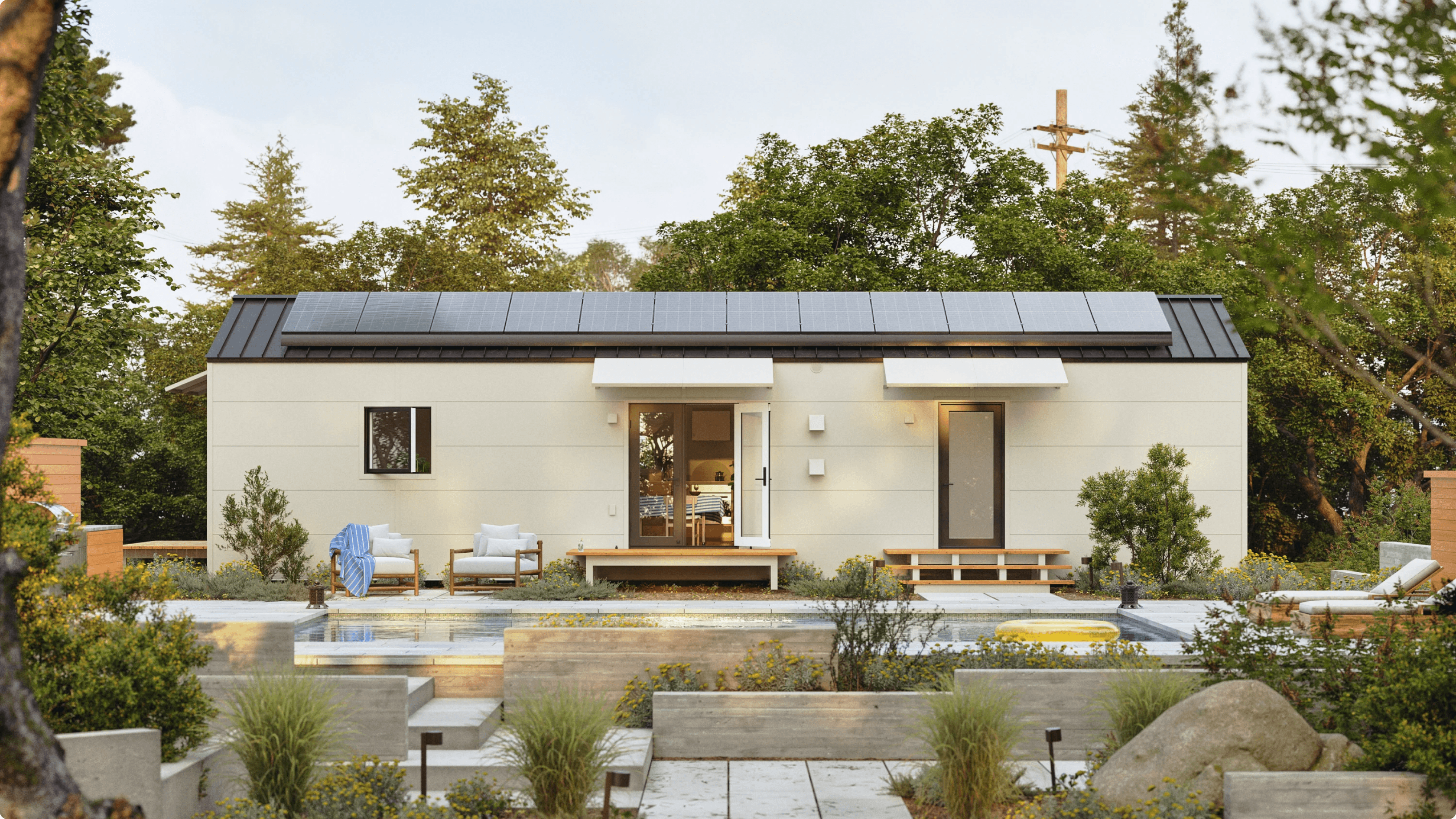Container house with solar panels beside a pool and garden